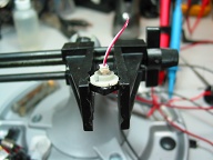 Used JB-Weld to hold the nylon shoulder washer to back of switch. The washer is a perfect friction fit into the switch housing allowing removal without light disassembly