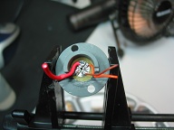 Used an old Fenix tail switch circuit board and Dremeled out 4 traces from a single center contact and sized to fit inside Delrin washer.